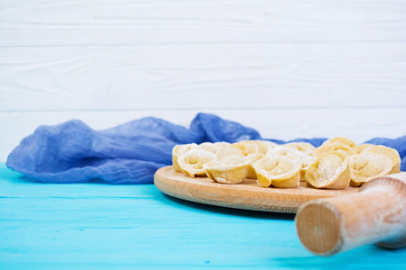 Homemade raw dumplings, pelmeni, on wooden background.の写真素材