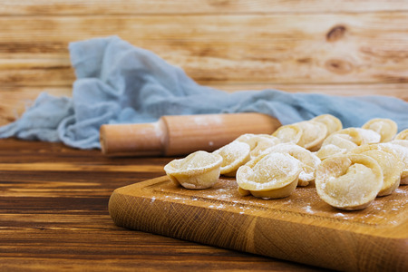 Homemade raw dumplings, pelmeni, on wooden background.の写真素材