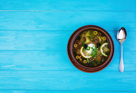 Russian soup solyanka with sour cream on wooden backgroundの写真素材