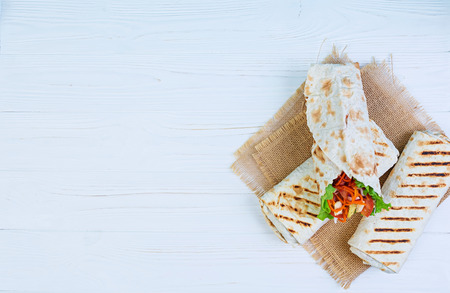 Delicious shawarma sandwich on wooden backgroundの写真素材