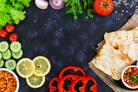 Quesadilla with chicken and corn on dark background. Top viewの写真素材