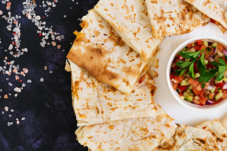 Quesadilla with chicken and corn on dark background. Top view