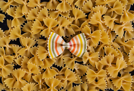 Mixed colorful farfalle pasta. Flat lay. Top view.の写真素材