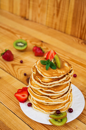 Delicious pancakes on wooden backgroundの写真素材