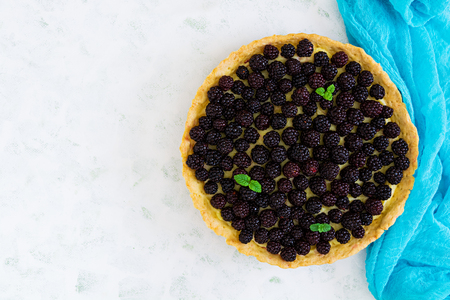 Delicious tart with blackberries on white background. Top viewの写真素材