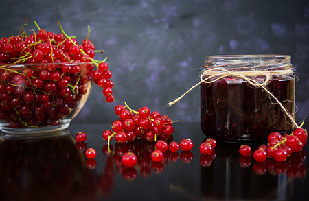 Jar with jam of red currant on dark backgroundの写真素材