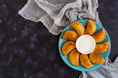 Baked dumplings on dark background. Top viewの写真素材