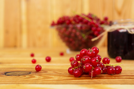 Jar with jam of red currant on a wooden backgroundの写真素材