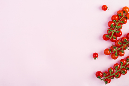 Isolated fresh red cherry tomatoes on pink background. Top view. Flat layの写真素材
