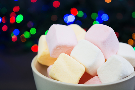 Cup of marshmallows on Christmas backgroundの写真素材