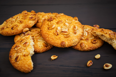 Cookies with peanuts on dark wooden backgroundの写真素材