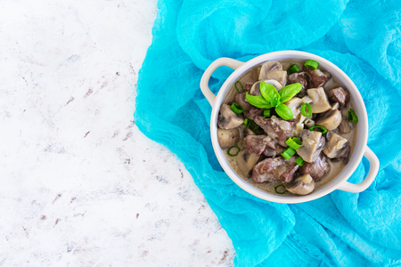 Beef stroganoff chicken liver and mushrooms on white backgroundの写真素材