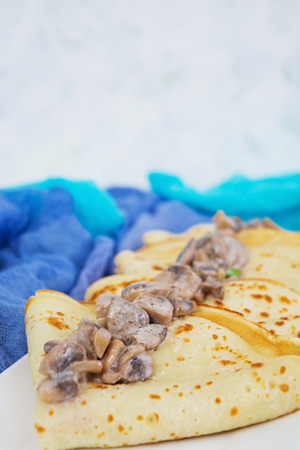 Pancakes with mushrooms on white backgroundの写真素材