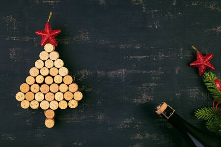 New Year decoration with christmas tree made of wine corks and bottle of champagne. Christmas background. Top view.の写真素材