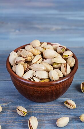 Pistachio nuts on wooden background. Roasted salted pistachios.の写真素材