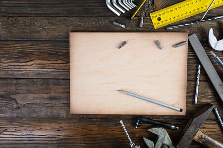 Set of working tools on wooden rustic background. Top view. Copy spaceの写真素材
