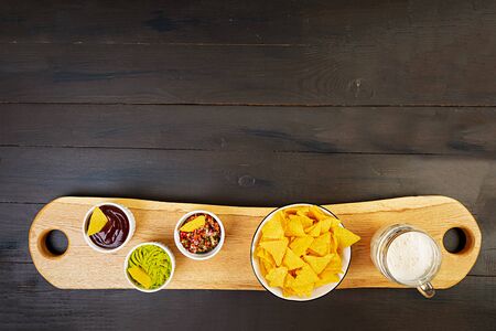 Mexican nachos with cheese. Corn chips with guacamole, salsa and tomato ketchup.の写真素材