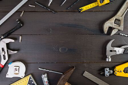 Set of working tools on wooden rustic background. Top view. Copy space