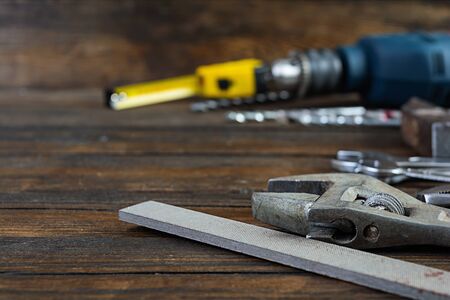 Set of working tools on wooden rustic background