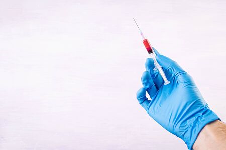 Viral disease protection. Disease and epidemic prevention. Syringe in hands