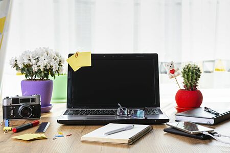 Workplace with notebook laptop at home. Workplace at pandemic coronavirus quarantine concept.