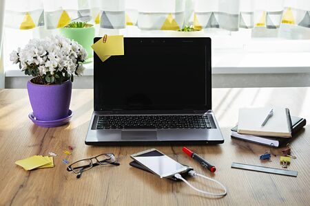 Workplace with notebook laptop at home. Workplace at pandemic coronavirus quarantine concept.の写真素材