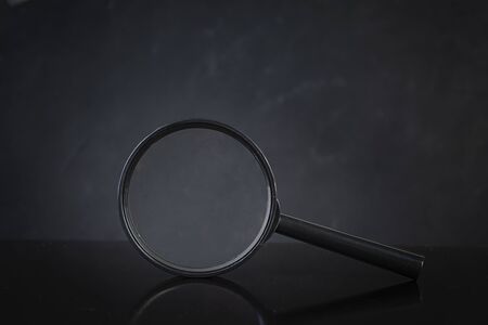 Search concept. Magnifying glass on dark backgroundの写真素材