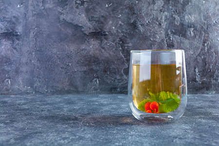 Glass cup with berry green tea and mint.の写真素材