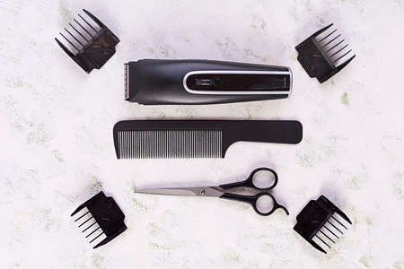Hairdresser tools on wooden background. Haircut accessories concept. Top view