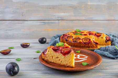 Delicious homemade plum pie on wooden backgroundの写真素材