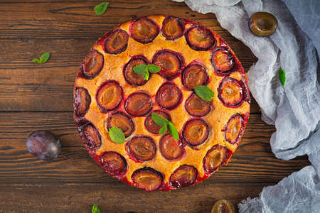 Delicious homemade plum pie on rustic background. Top viewの写真素材