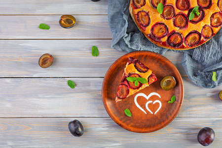 Delicious homemade plum pie on wooden background. Top viewの写真素材