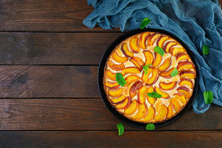 Delicious homemade peach pie on wooden background. Top viewの写真素材