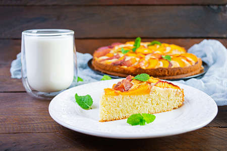 Delicious homemade peach pie on wooden backgroundの写真素材