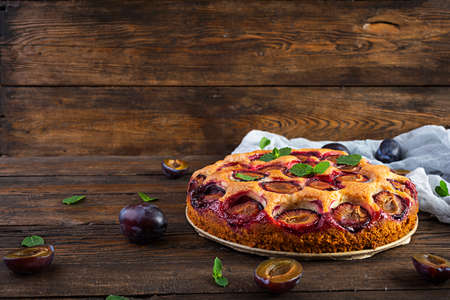 Delicious homemade plum pie on rustic backgroundの写真素材