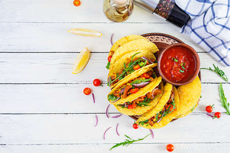 Mexican tacos with corn tortilla and meat on wooden background. Top viewの写真素材