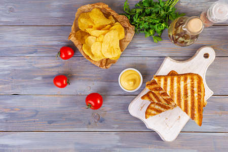 Club sandwich with ham, cheese, tomato, salad and chips. Top viewの写真素材