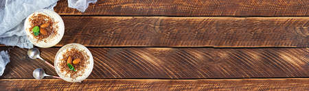 Sweet milk pudding with almonds and chocolate chips on wooden backgroundの写真素材