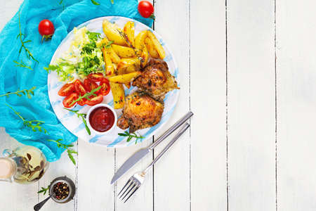 Delicious baked chicken with potatoes on wooden background. Top view
