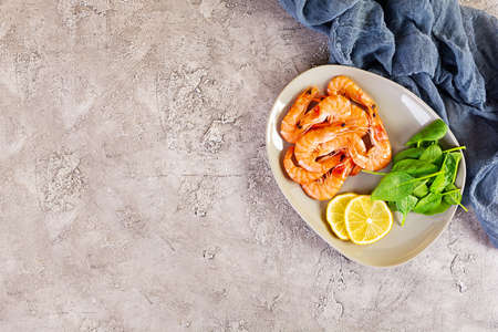 Delicious cooked shrimps in plate isolated on gray background. Boiled prawnsの写真素材