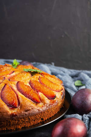 Delicious plum cake on wooden background. Homemade plum pieの写真素材