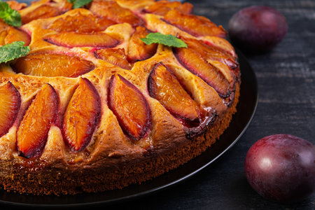 Delicious plum cake on wooden background. Homemade plum pieの写真素材