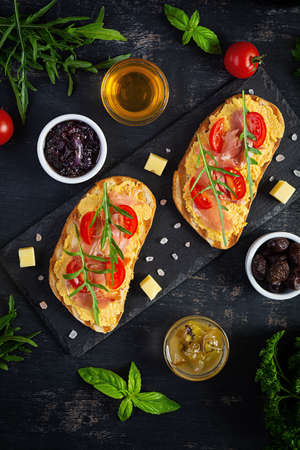 Grilled bruschetta with chicken rillettes, jamon and herbs. Delicious toast with chicken pate and different appetizersの写真素材