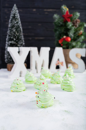 Meringue cookies with Christmas decoration. French dessert. Christmas tree of meringueの写真素材