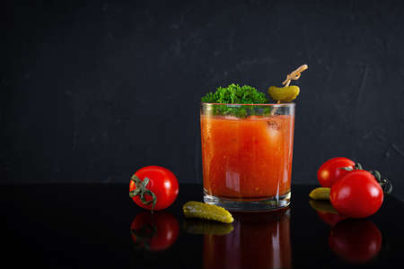 Alcohol cocktail Bloody Mary on dark background. Classic cocktail with tomato juice and vodkaの写真素材