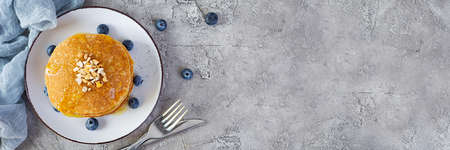 Delicious homemade pancakes with honey and blueberries. Tasty breakfast with crepes. Top viewの写真素材