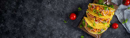 Mexican tacos with corn tortilla. Tortilla with chicken meat, corn, lettuce and onion. top viewの写真素材