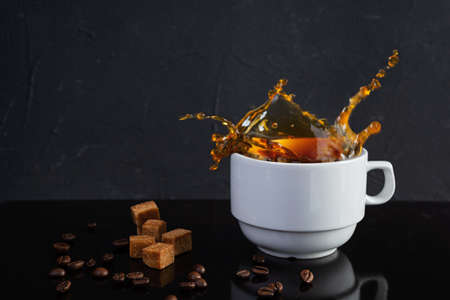 Cup of coffee with sugar and coffee beans on dark backgroundの写真素材
