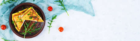 Roasted toast in scrambled eggs with ham, herbs and cheese cheddar. Delicious grilled breakfast sandwichの写真素材