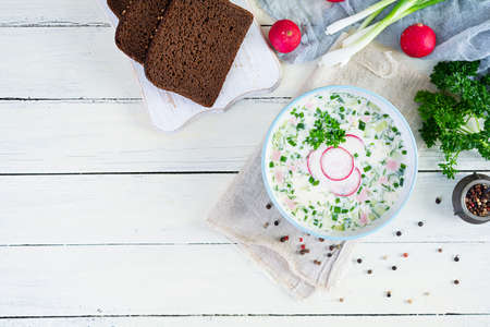 Summer cold soup with yogurt and vegetables. Traditional russian cold soup okroshka. top viewの写真素材